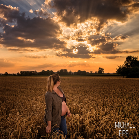 Babybauch Shooting im Getreidefeld bei Sonnenuntergang – Portraitfotografie